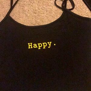 A crop top . Black . With the words happy . 2xl